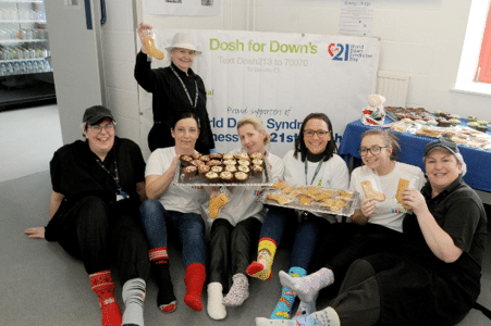 Fundraisers in odd socks and sock biscuits for Down Syndrome Cheshire